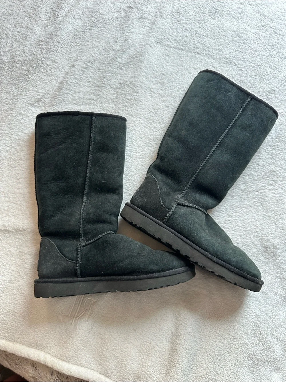 Tall black UGG boots